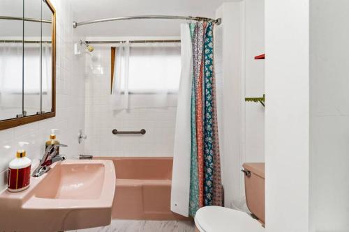 een badkamer met een wastafel, een bad en een toilet bij The Vintage Haven in Des Moines