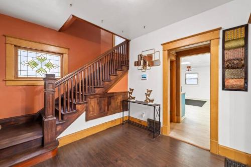 a hallway with a wooden staircase in a home at The Vintage Haven in Des Moines