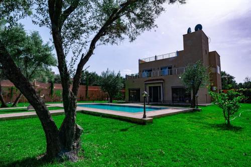 a house with a swimming pool in a yard at villa ourika view on mountain in Sbiti
