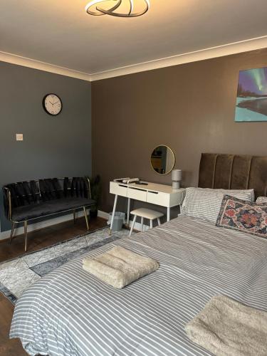 a bedroom with a bed and a desk and a table at Amazing Ground Floor one bedroom apartment Forest Road in London