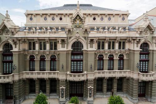 a large building with a clock on the front of it at Hotel Villanueva San Jorge de Heres in Villanueva