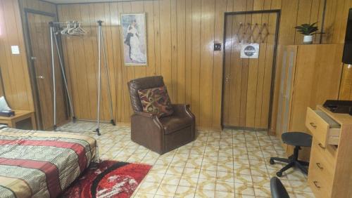 ein Schlafzimmer mit einem Bett und einem Stuhl darin in der Unterkunft Spacious Suite 1 BR Independent Near Toronto YYZ Airport in Mississauga