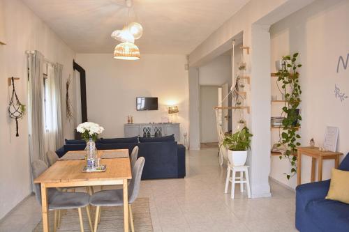 a living room with a table and a blue couch at Nature et al House - Casa para uso exclusivo e jardim - Little farm in Batalha