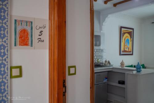 a kitchen with a door leading into a kitchen with a counter at Dar Jinane in Chefchaouene