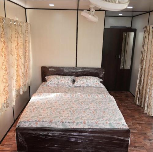 a bedroom with a large bed with a wooden headboard at Birds of paradise foundation in Bangalore