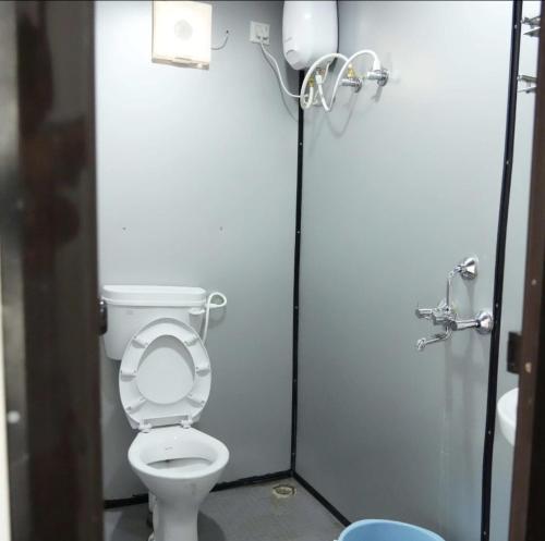 a bathroom with a toilet in a stall at Birds of paradise foundation in Bangalore