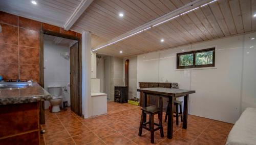 a bathroom with a table and a sink and a toilet at Cabaña quinta do Conde in Ponteareas