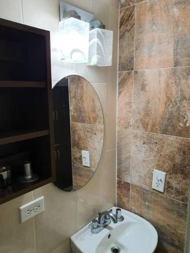 a bathroom with a sink and a mirror at R.1114 Estudio ejecutivo privado, con cocina y baño. in Panama City