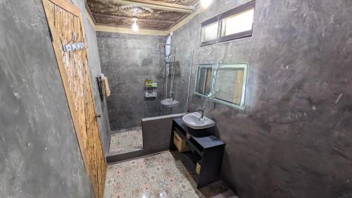 a bathroom with a sink and a shower at Tropical Haven with Dedicated Office Space in Siargao in General Luna