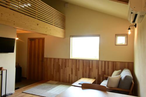 a living room with a couch and a window at mizuki - Vacation STAY 12130v in Higashikawa