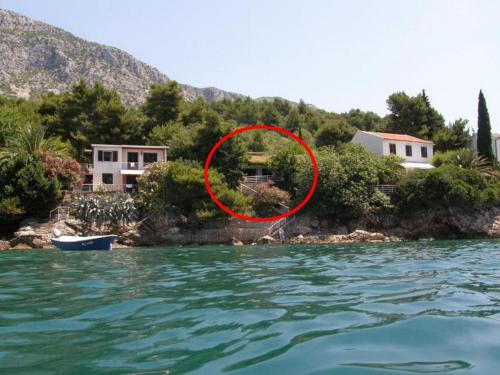 a house on the shore of a body of water at Seaside holiday house Podaca, Makarska - 22964 in Podaca