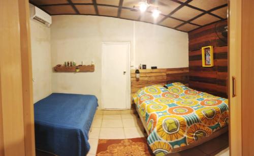 um quarto com duas camas e uma porta em La Casita em El Zonte