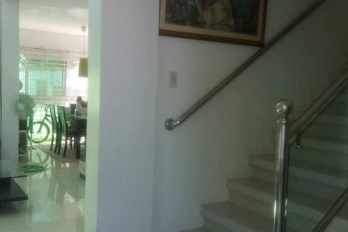 a staircase in a living room with a picture on the wall at White House near Thunderbird Resort in Parian