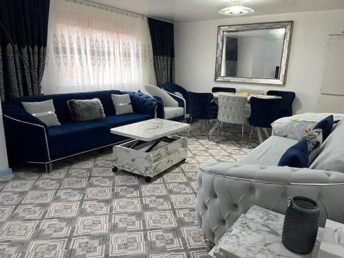 a living room with a blue couch and a table at Entire flat In cardiff central in Cardiff