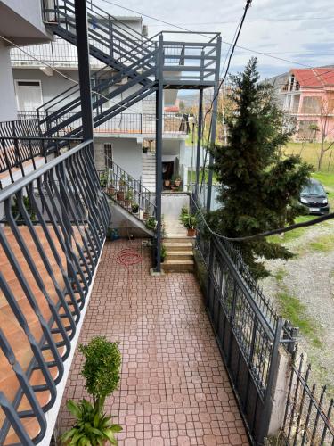 a staircase leading to a house with a fence at Apartment 040 in Velipojë