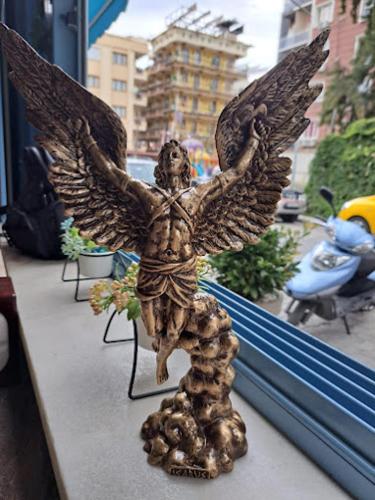 a statue of an angel sitting on a window sill at İkarus Hotel in Kusadası