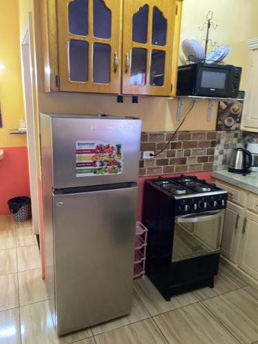 a kitchen with a refrigerator and a stove at Lusignan selfcontain apart two br and onebath in Georgetown