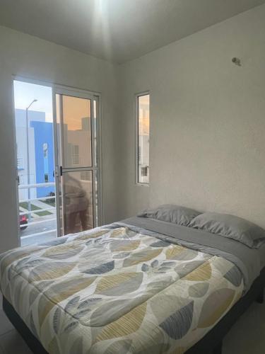 a bedroom with a large bed with a window at Casa Regina in Gallinero