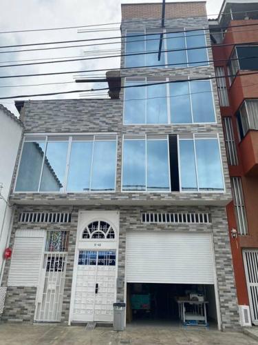 a building with a lot of glass windows on it at Hotel Orduz Centro Histórico de Cali in Cali