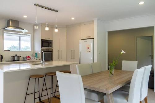 a kitchen and dining room with a wooden table and chairs at memory in Auckland