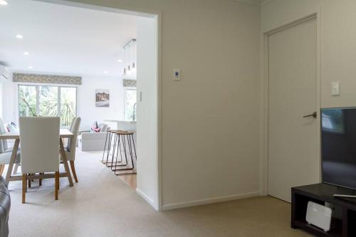 a living room with a television and a dining room at memory in Auckland