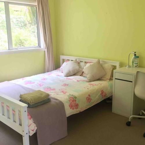 a bedroom with a bed and a window and a desk at memory in Auckland