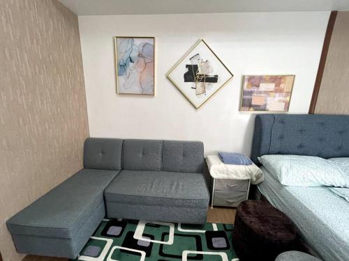 a living room with a couch and a bed at CityView Condo w/ balcony-14 in Cagayan de Oro