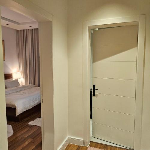 a door leading to a bedroom with a bed at استديو. الياسمين للإيجار اليومي و دخول ذاتي. in Riyadh