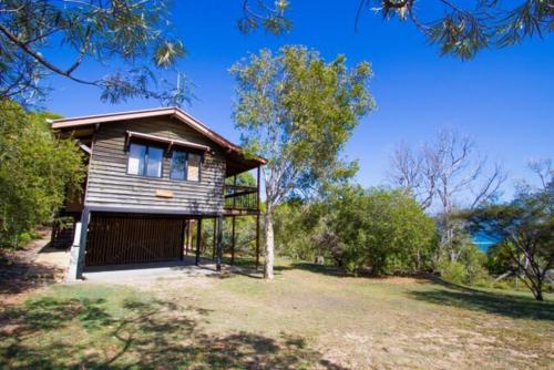 a small house in the middle of a field at Bimbimbi - Unique Two-Bedroom, Serene Holiday Hideaway with Gorgeous Views in Historic 1770 in Seventeen Seventy