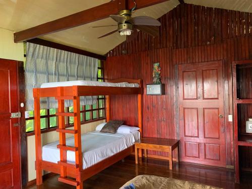 a bedroom with two bunk beds and a ceiling fan at VistaDrake Bungalow in Drake