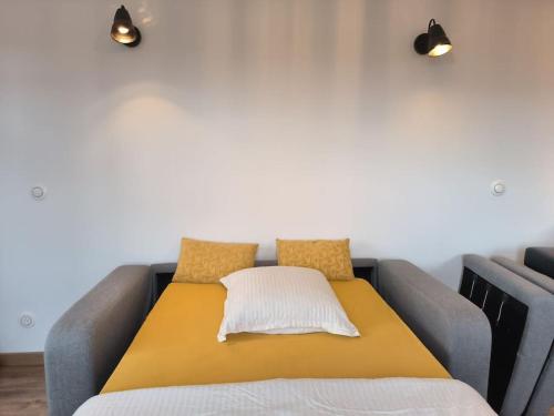 a bed with two pillows on top of it at ô vive studio in Monnetier-Mornex