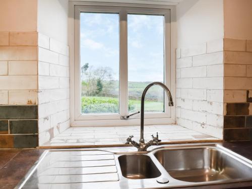 a kitchen with a sink and a window at Mitsys Cottage in Darley