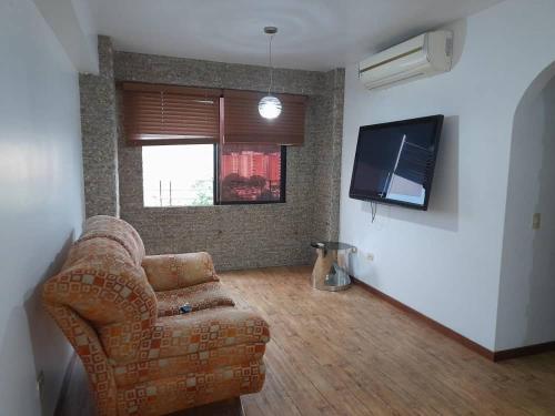 a living room with a couch and a flat screen tv at Apartamento En Valencia in Valencia