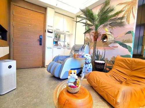 a living room with an orange couch and a chair at Interact China Fine Condo - Shenzhen Bay in Shenzhen