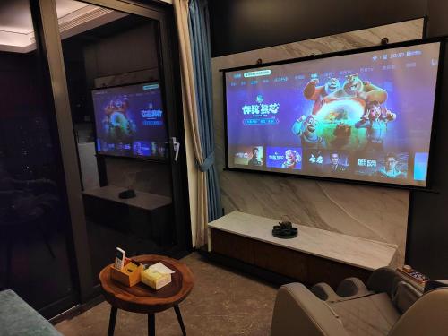 a room with a large screen with a video game at Interact China Fine Condo - Shenzhen Bay in Shenzhen