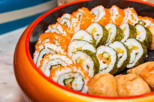 an orange bowl filled with sushi and vegetables at Shanghai Haichang Ocean Park Resort Hotel in Shanghai