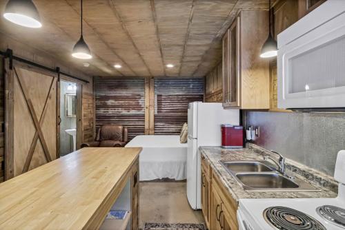 a kitchen with a sink and a refrigerator at Casas Coastal Experience Cabin A in Rockport