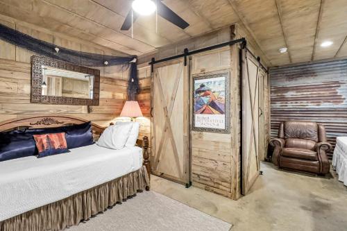 a bedroom with a bed and a chair in a room at Casas Coastal Experience Cabin A in Rockport