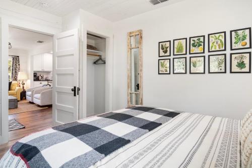 a white bedroom with a black and white bed at Hill Country Mirage in Bandera