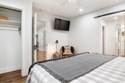 a bedroom with a bed and a tv on the wall at Hill Country Mirage in Bandera