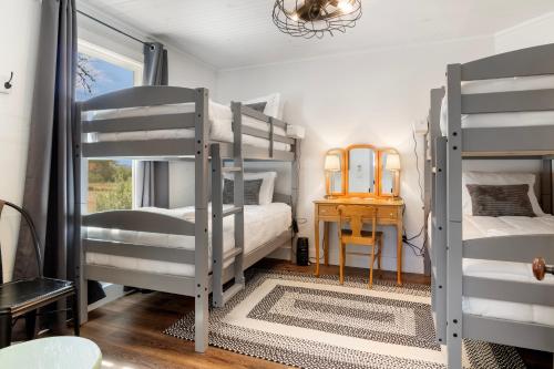 a room with three bunk beds and a table at Hill Country Mirage in Bandera