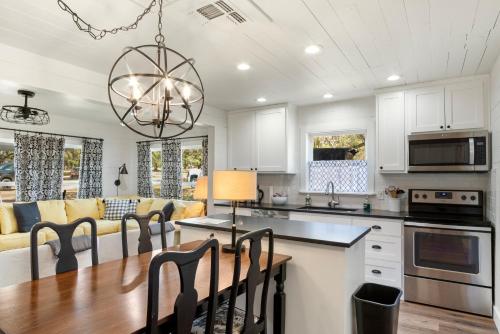 a kitchen and living room with a table and chairs at Hill Country Mirage in Bandera