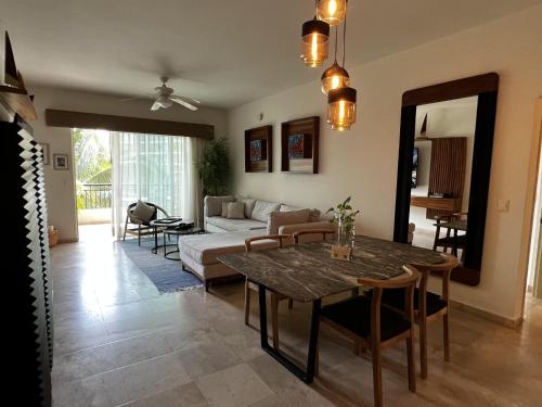 a living room with a table and a couch at Beachfront 2 bedroom Condo in Playa Royale Resort, Nuevo Vallarta in Nuevo Vallarta