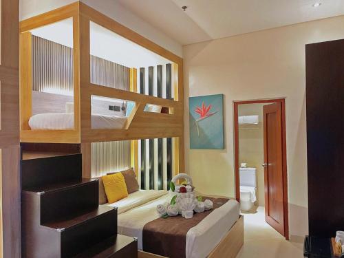 a bedroom with a bunk bed and a bathroom at Aloha Boracay Hotel in Boracay