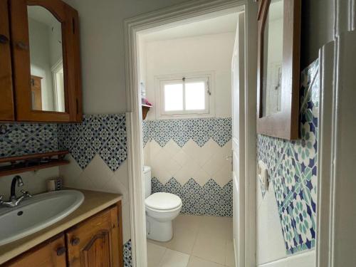 a bathroom with a toilet and a sink at Le 5éme Penthouse cosy with sea view in Sousse