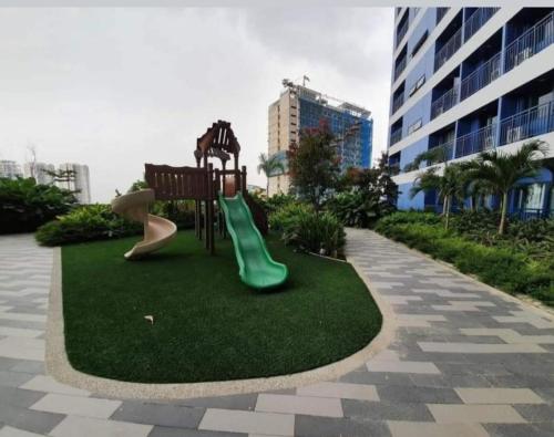 a playground with two slides on the grass at UNIT 4765 AIR in Manila