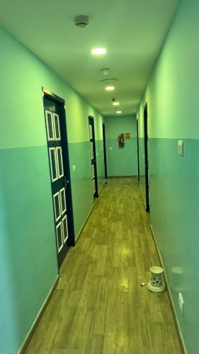 an empty hallway with green walls and a door at PHP BOUTIQUE TOWNHOUSE in Chennai