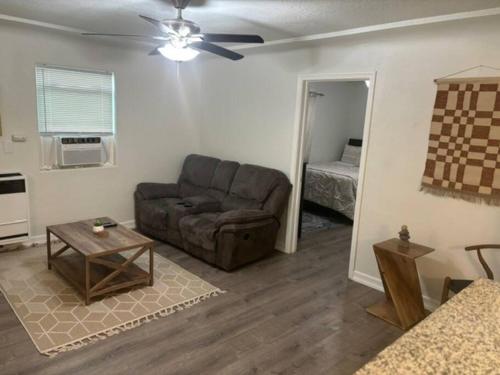 a living room with a couch and a table at Casita Mariposa Verde in Sanger