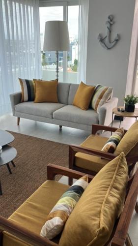a living room with couches and a couch and a table at Casa Cielo Vallarta V-Golf in Puerto Vallarta
