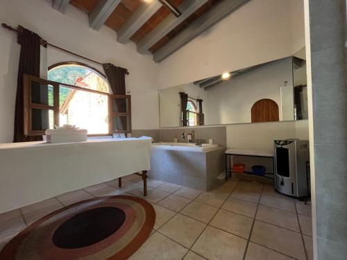 a bathroom with a large sink and a large mirror at Hotel Hacienda Ventana del Cielo in Tepoztlán